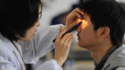 An examinee takes an ophthalmic test during a military pilot selection in Wuhan